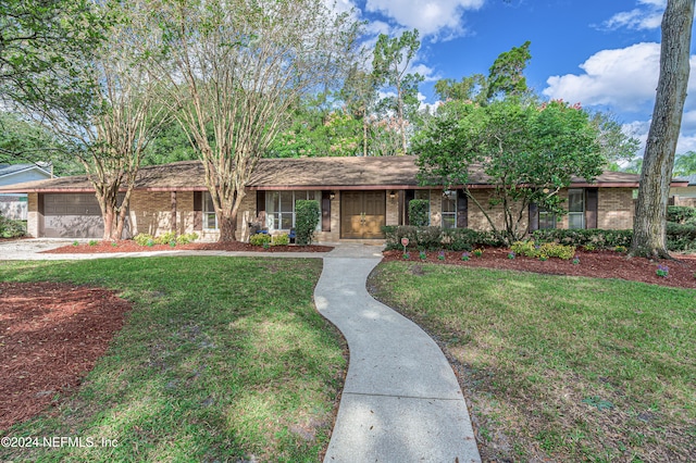 ranch-style home featuring a garage and a front yard