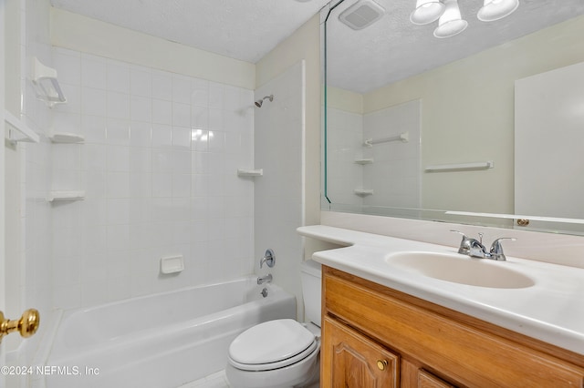 full bathroom with vanity, a textured ceiling, toilet, and tiled shower / bath