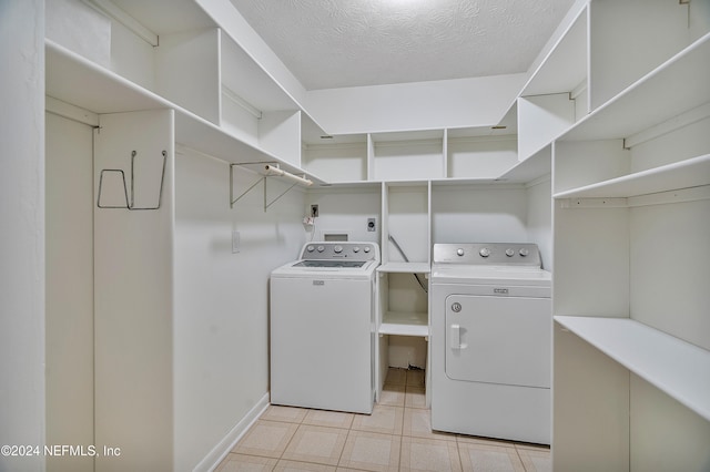 washroom with separate washer and dryer and a textured ceiling