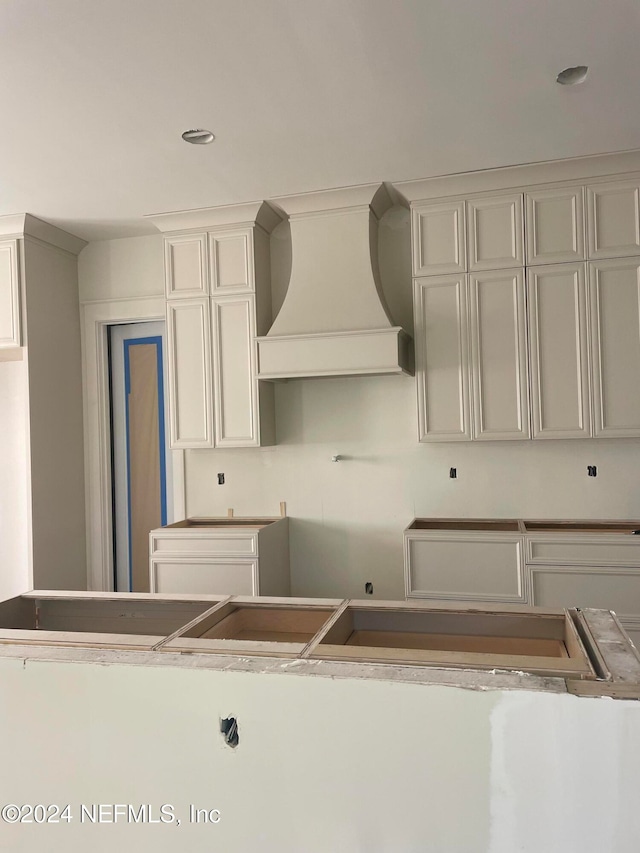 kitchen with custom range hood