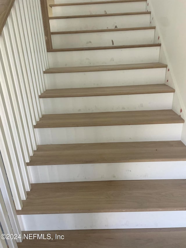 stairs with hardwood / wood-style floors