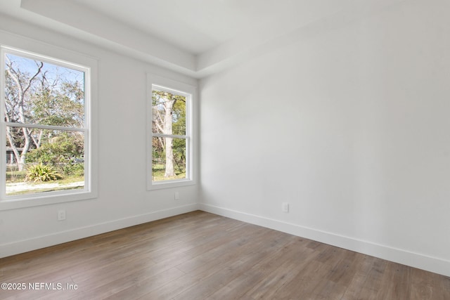 unfurnished room featuring light wood-style flooring and baseboards