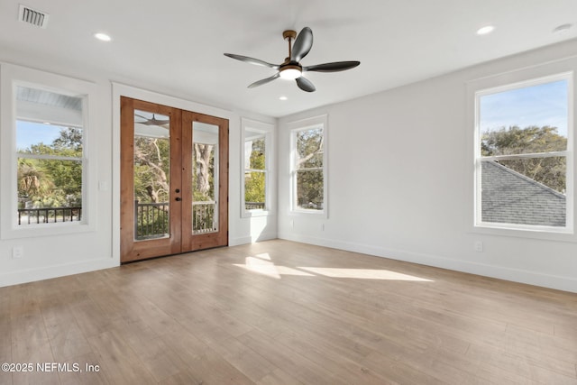 entryway featuring visible vents, light wood finished floors, a healthy amount of sunlight, and french doors