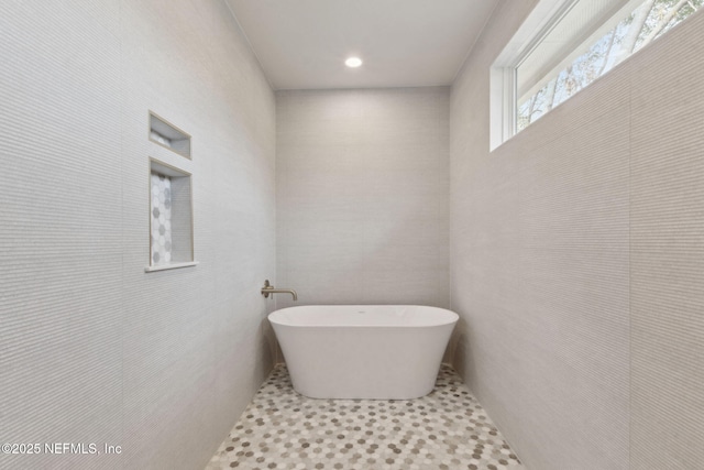 bathroom featuring a soaking tub