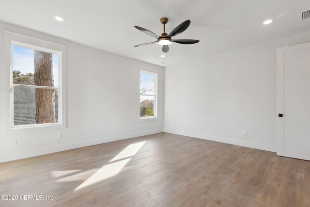 unfurnished room with recessed lighting, visible vents, baseboards, and wood finished floors