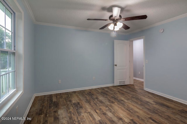 spare room with a textured ceiling, dark hardwood / wood-style floors, crown molding, and ceiling fan