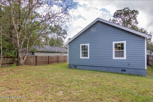 view of side of home featuring a lawn