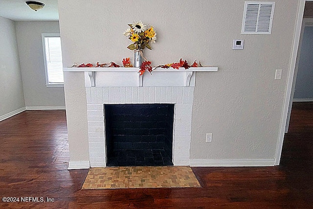 room details with hardwood / wood-style floors and a brick fireplace