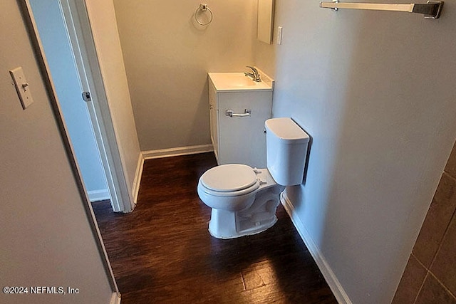 bathroom with hardwood / wood-style floors, vanity, and toilet