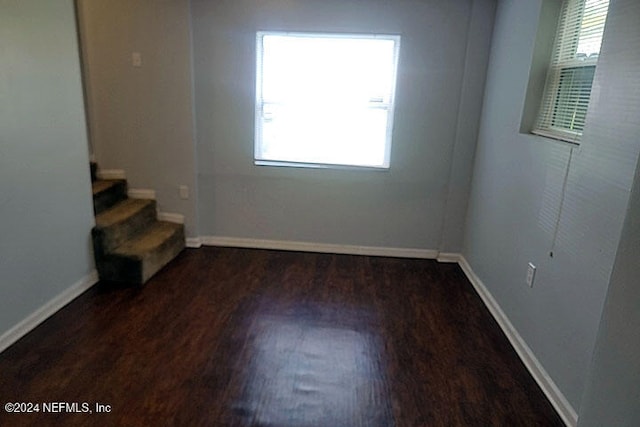 unfurnished room featuring dark wood-type flooring