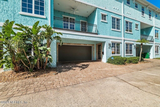 view of front of house with a garage and a balcony