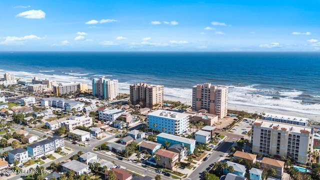 bird's eye view featuring a water view and a beach view