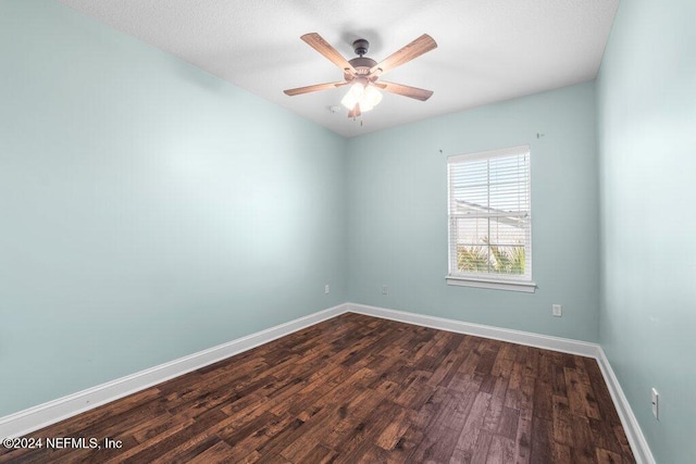 spare room featuring dark hardwood / wood-style flooring and ceiling fan