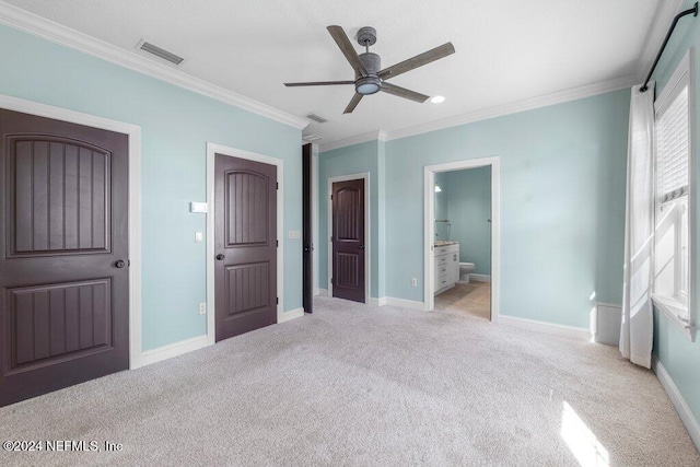 unfurnished bedroom with ceiling fan, ensuite bathroom, light colored carpet, and ornamental molding