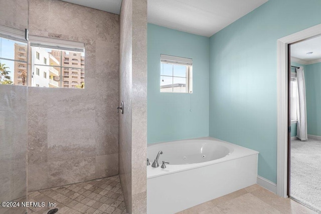 bathroom featuring tile patterned floors and plus walk in shower