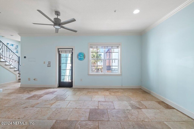 empty room with ceiling fan and crown molding