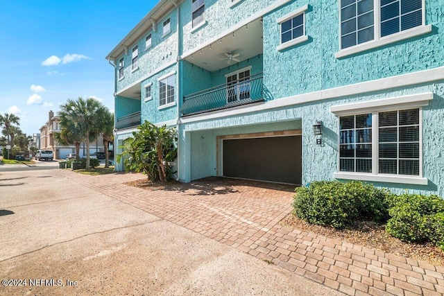 view of home's exterior featuring a garage and a balcony