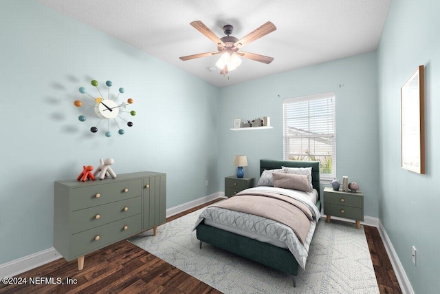 bedroom with dark wood-type flooring and ceiling fan