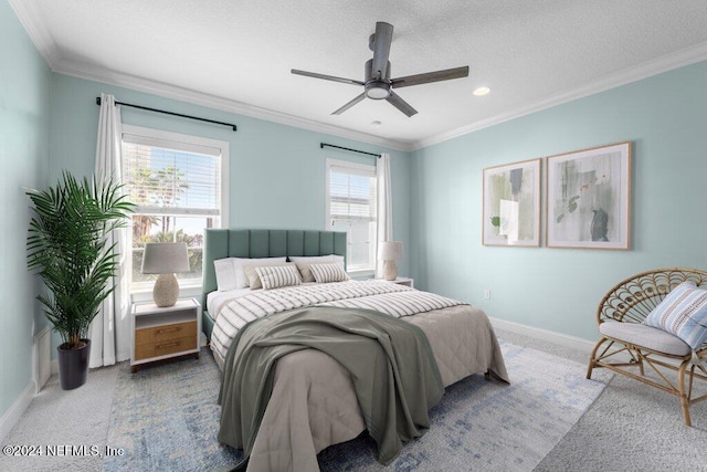 carpeted bedroom with multiple windows, a textured ceiling, ceiling fan, and crown molding