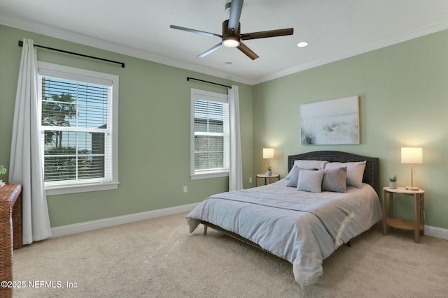 carpeted bedroom with multiple windows, a ceiling fan, baseboards, and ornamental molding