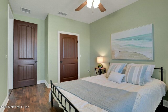 bedroom featuring ceiling fan, wood finished floors, visible vents, and baseboards