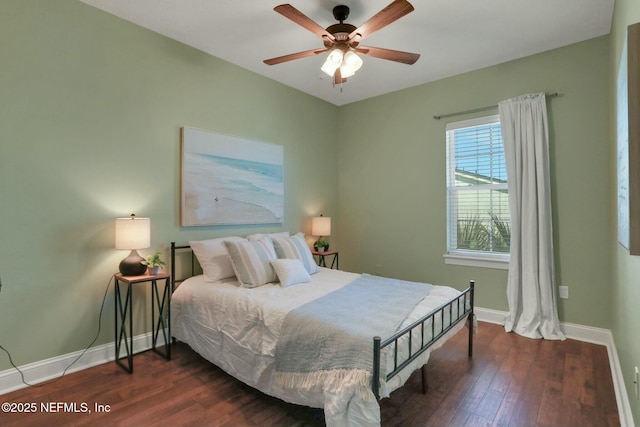 bedroom featuring dark wood-type flooring, a ceiling fan, and baseboards