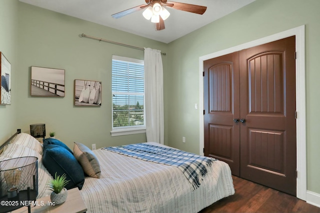 bedroom featuring ceiling fan, a closet, and dark wood-style floors