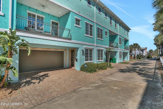 exterior space with decorative driveway and a garage