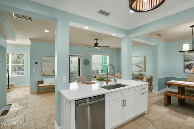 kitchen with stone tile floors, visible vents, dishwasher, and a sink