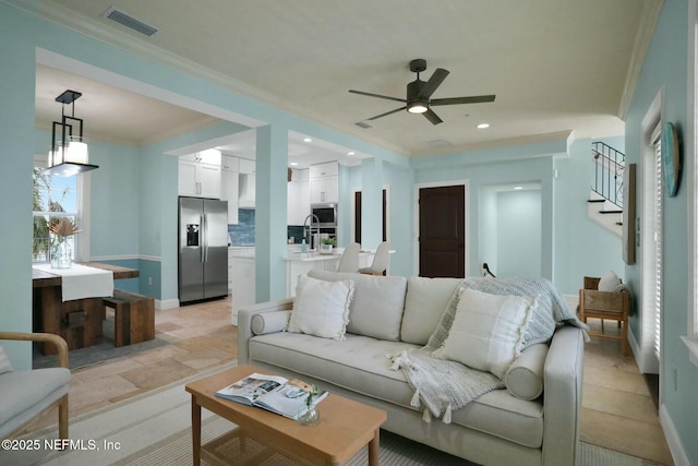 living room with visible vents, recessed lighting, ceiling fan, stairs, and ornamental molding