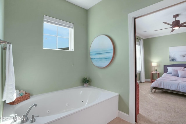 bathroom with plenty of natural light, a jetted tub, ensuite bath, and baseboards