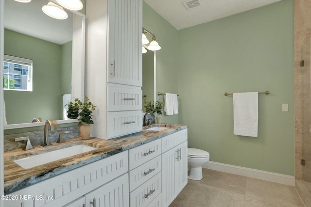 bathroom featuring a sink, visible vents, baseboards, and double vanity