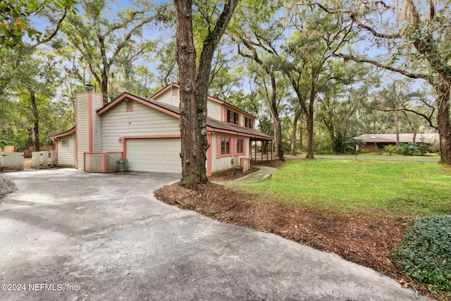 view of side of home with a yard and a garage