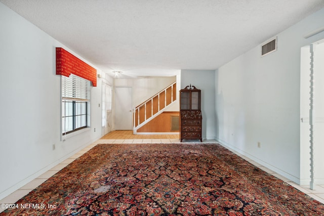 unfurnished living room with light tile patterned flooring