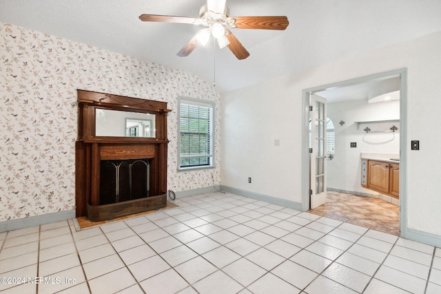 300 Raintree Trl, Saint Augustine, FL 32086 - unfurnished living room with wallpapered walls, baseboards, ceiling fan, light tile patterned floors, and a fireplace with raised hearth