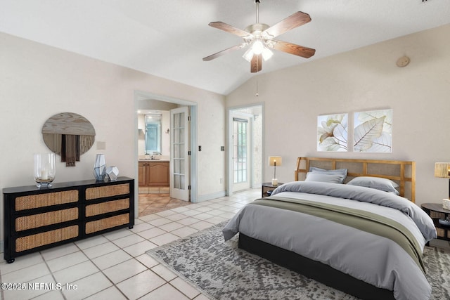 tiled bedroom with ensuite bathroom, vaulted ceiling, ceiling fan, and sink