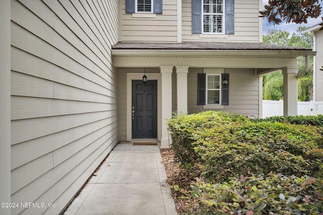 doorway to property with fence