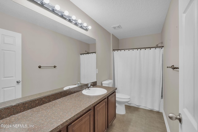 full bath featuring a textured ceiling, tile patterned flooring, toilet, vanity, and visible vents