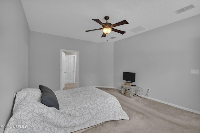 carpeted bedroom with a textured ceiling, visible vents, and baseboards