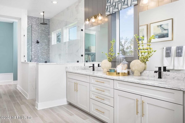 bathroom featuring vanity and a tile shower