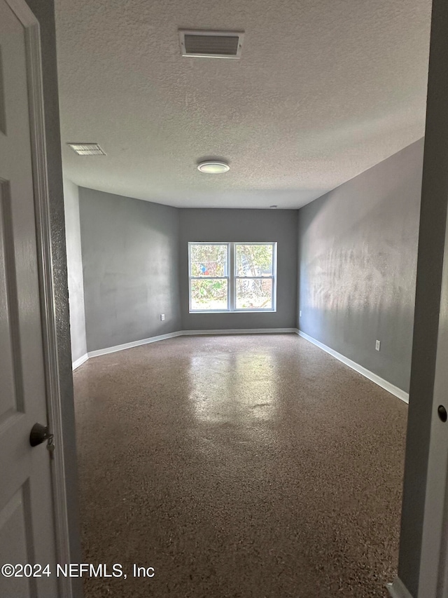 empty room featuring a textured ceiling