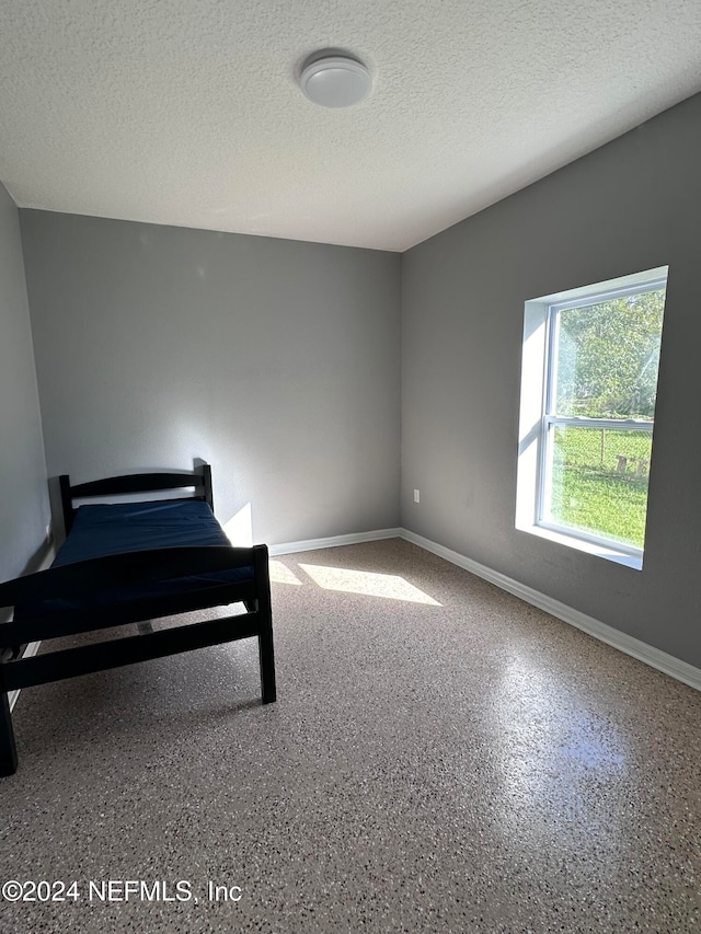 unfurnished bedroom featuring a textured ceiling