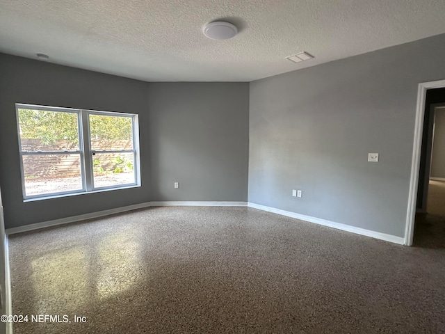 empty room with a textured ceiling