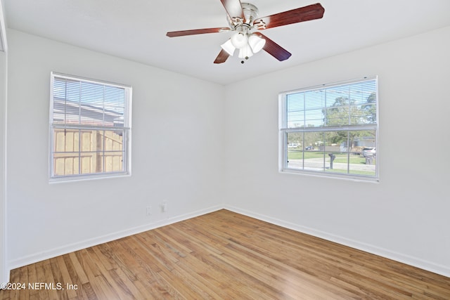 empty room with ceiling fan and wood-type flooring