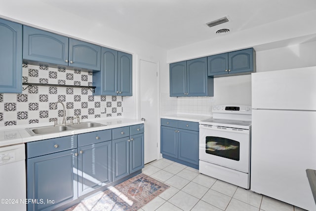 kitchen with tasteful backsplash, blue cabinetry, white appliances, and light tile patterned flooring