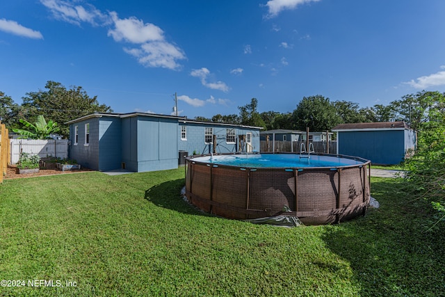 view of swimming pool with a yard and a shed