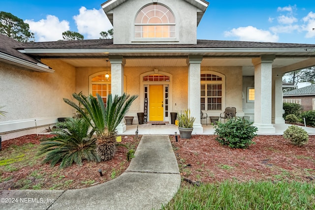 doorway to property featuring covered porch