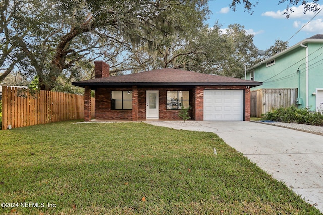 ranch-style house featuring a front lawn and a garage