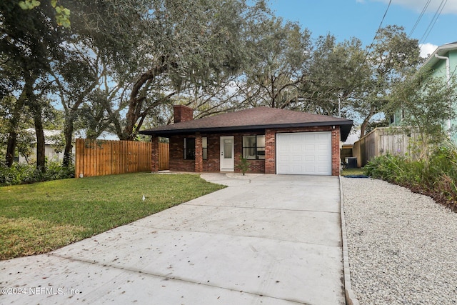 view of front of property featuring a garage and a front lawn