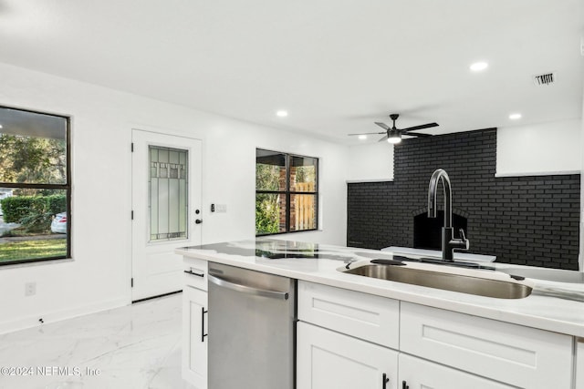 kitchen featuring white cabinetry, stainless steel dishwasher, sink, and ceiling fan